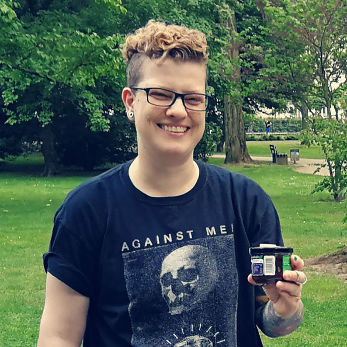 Queer Pack Crossmedia Expert Sam Achilles, wearing an Against Me shirt